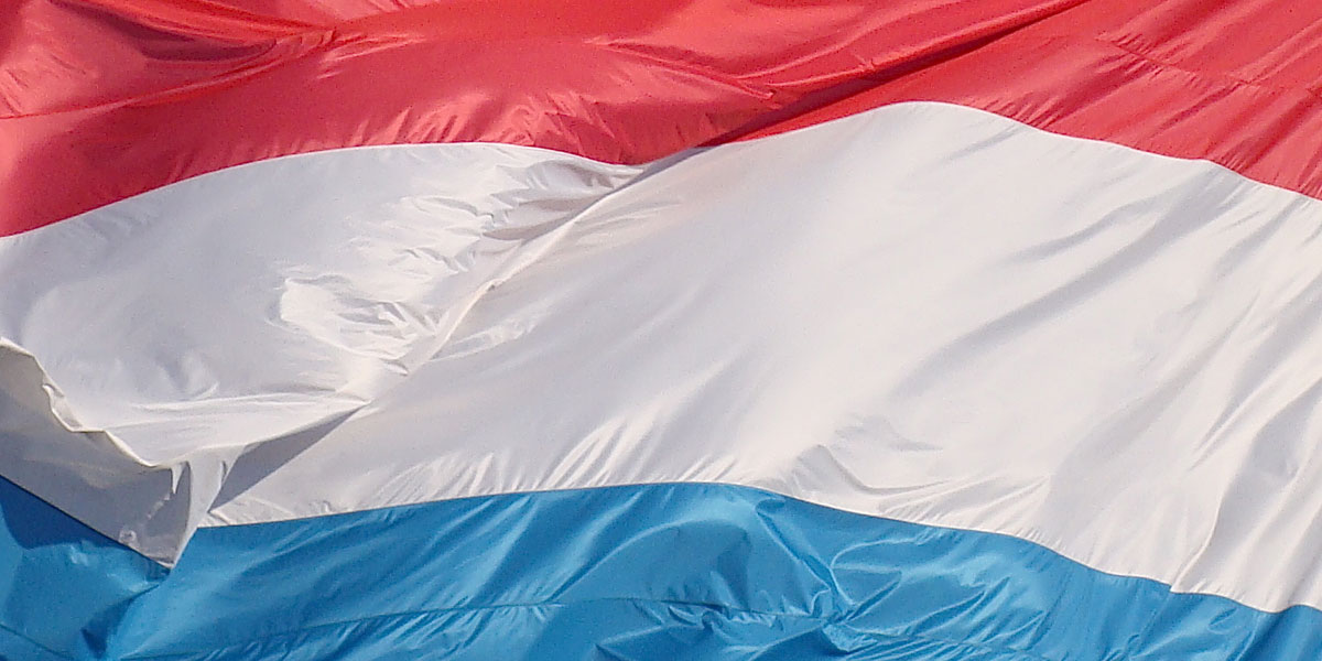 A close up of the flag of Luxembourg flying.